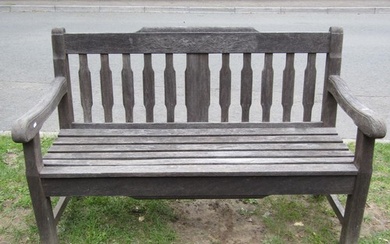 A heavy gauge weathered teak garden bench with slatted seat ...
