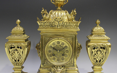 A late Victorian brass cased mantel clock with eight day movement striking on a gong, the pierced di