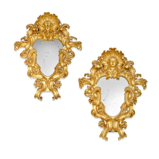A monumental pair of Italian Baroque carved giltwood mirrors