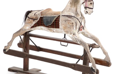 A painted French wooden rocking horse. Late 19th century. H. 120 cm....