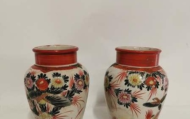 A pair of Japanese Kutani porcelain vases, hand painted with...