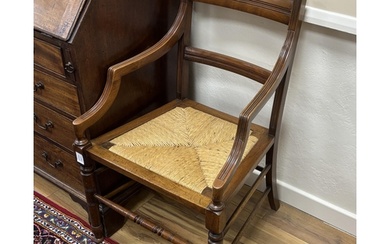 A pair of late Victorian Arts & Crafts mahogany rush seat el...