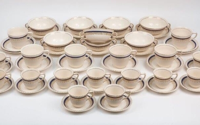 A quantity of Johnson Bros. tea and coffee wares, 20th century, of cream ground with cobalt blue and gilt bordering, comprising: eight twin handled soup bowls, 12.5cm diameter, with twelve saucers, 15.5cm diameter, six teacups, 8.5cm diameter, with...