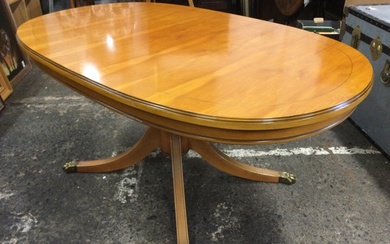 A regency style yew coffee table with moulded oval mahogany...
