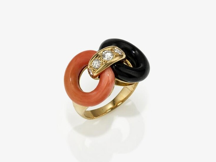 A ring with a coral circle and onyx circle