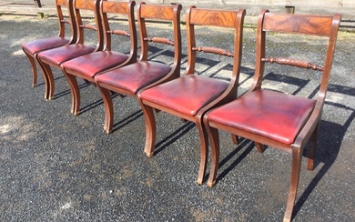 A set of six regency style mahogany dining chairs with...