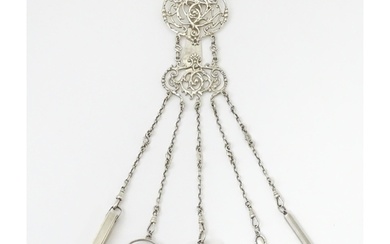 A silver chatelaine with openwork scrolling detail and havin...