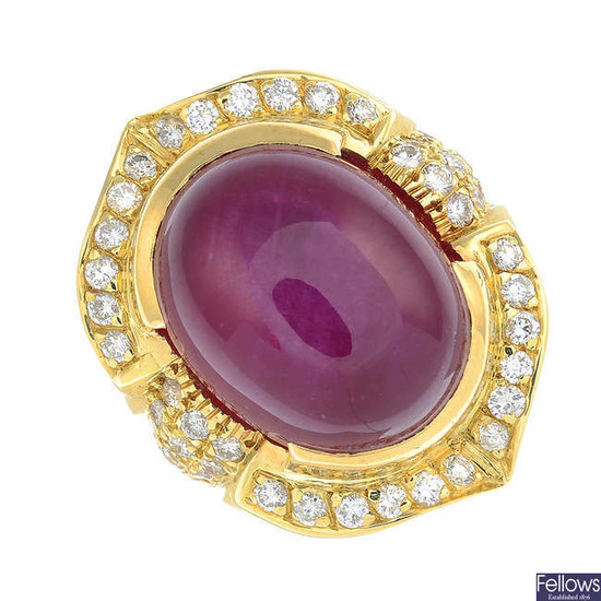 A star ruby oval cabochon and brilliant-cut diamond dress ring.