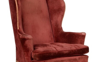 A walnut and upholstered wing armchair in George II style