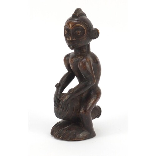 African tribal interest carved wood figure of a drummer from...