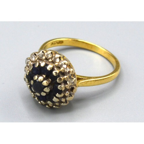 An 18ct Gold Sapphire and Diamond Cluster Ring with a centra...