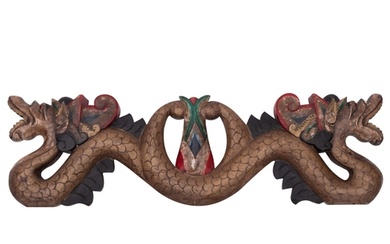 An Indonesian carved and painted wood transom in the form of...