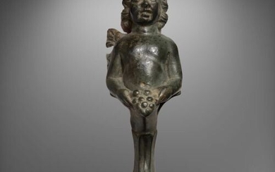 Ancient Roman Bronze ''Leg'' of a Luxury Box or Furniture shaped as a Figurine of an Eros holding Grapes with both hands.