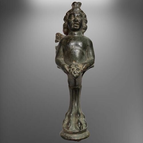 Ancient Roman Bronze ''Leg'' of a Luxury Box or Furniture shaped as a Figurine of an Eros holding Grapes with both hands.