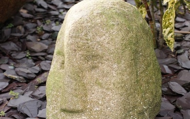 Antique carved stone head weathered with distinctive nose, f...