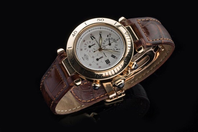 CARTIER. WATCH BRACELET chronograph model PASHA 1847, circa 1997 in 750-thousandths yellow gold, with unidirectional rotating bezel, white dial with three counters showing the hours in Roman numerals and the minutes in Arabic numerals. The dial at 12...