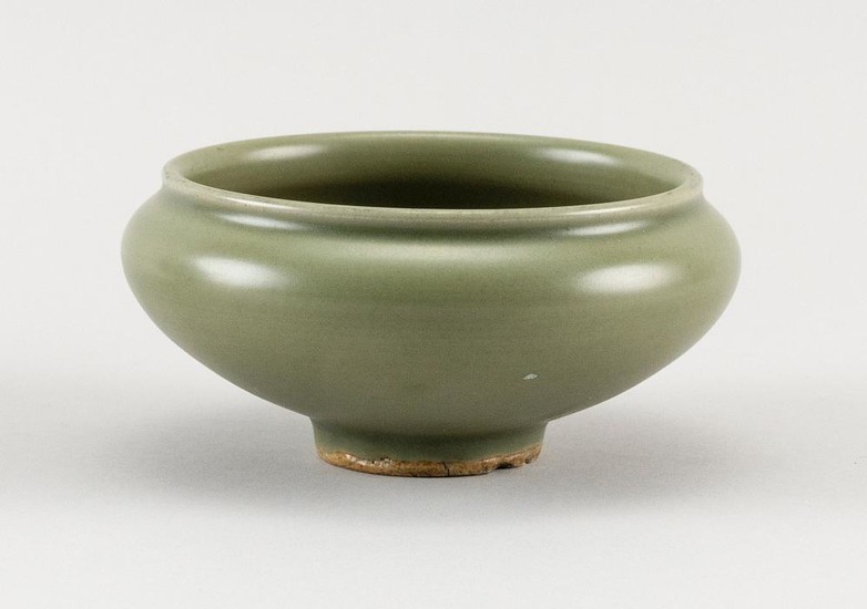 CHINESE LONGQUAN CELADON PORCELAIN BOWL In ovoid form. Remnants of old label and deaccession mark near foot. Height 2.5". Diameter 4".