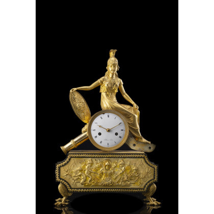 FALLOISE À PARIS Ormolu mantel clock modelled with martial motifs, surmounted by Athena’s figure on a cannon. Enamel dial...