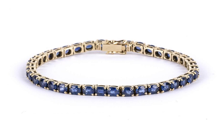 Gold and sapphires tennis bracelet 14k yellow gold, set with...