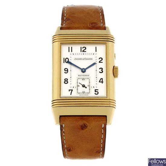 JAEGER-LECOULTRE - an 18ct yellow gold Reverso Night & Day wrist watch, 26x36mm.
