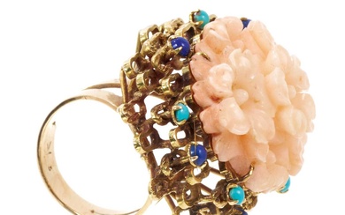 Large 1960s cocktail ring with a carved pink coral floral cluster in gold abstract setting scattered with lapis lazuli and turquoise cabochons, the cluster measuring approximately 43 x 30mm, ring s...