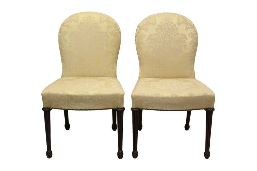 Pair of Mid-18th century style Continental mahogany upholstered side chairs, each with arched lemon silk damask upholstered back and fluted legs