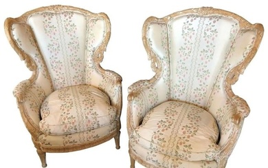 Pair of large impressive high back distressed carved framed wing back armchairs in a fine