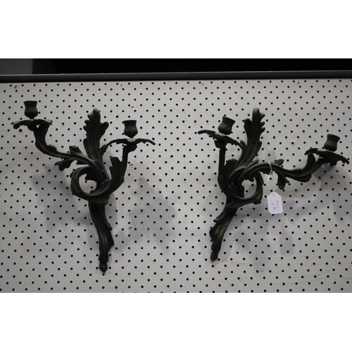 Pair of two cast iron wall mounted candle holders, each appr...