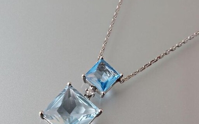 Pendant and its chain in 750 thousandths white gold, it is set with two square-cut falling topazes, the first Swiss Blue calibrating approximately 1.55 carats and the second Sky Blue calibrating approximately 5.75 carats interspersed with a modern cut...