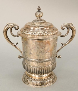Silver cup with cover and two scrolled handles. ht. 12