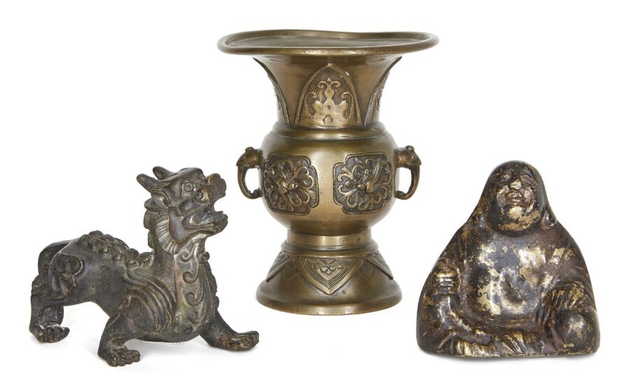 Three Chinese bronzes, late 19th century, with a gu vase cast with birds and archaistic motifs, a Sino-Tibetan figure of a temple lion, and a figure of Buddha, 8cm-12.5cm high (3)