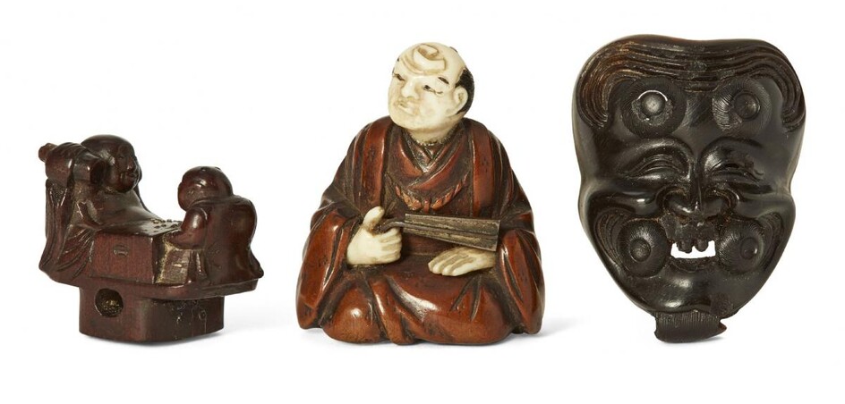 Three Japanese wood netsuke, 19th century, carved as Hotei and Karako playing Go; an Okina Noh mask; and seated nobleman with metal fan, hands and head of ivory, largest 4cm (3)