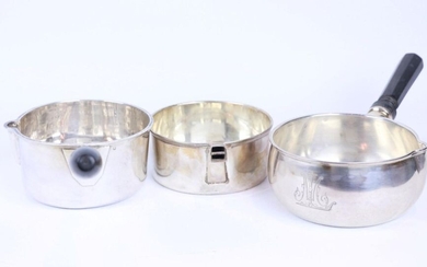 Three silver pots, two held by turned wooden handles.