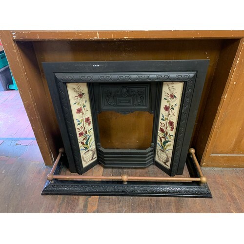 Vintage cast iron fire place decorated with hand painted til...