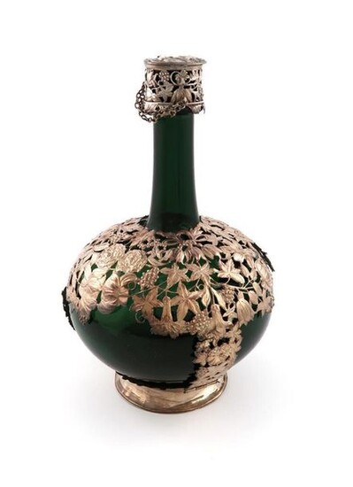 A 17th century Dutch silver-mounted green glass shaft and globe bottle, probably by Hans C. Brechtel, The Hague 1664, the mounts with pierced and embossed foliate and flower decoration, with damage, the cover with a silver-mounted cork stopper...