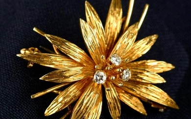 A 1970s 18ct gold brilliant-cut diamond textured floral brooch.Estimated total diamond weight