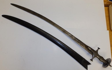 A 19thC Indian tulwar sword in scabbard, impressed marks...