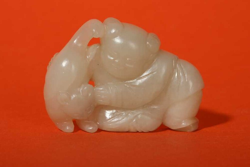 A CHINESE WHITE JADE 'BOY AND CAT' GROUP.
