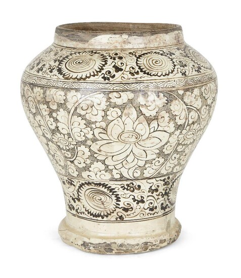 A Chinese stoneware Cizhou 'lotus and chrysanthemum' baluster jar, Ming dynasty, the rounded body painted with dark brown on white slip with large lotus and chrysanthemum blossoms amongst leafy stems and smaller flowerheads, enclosed with...