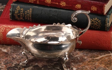 A George II silver sauce boat, acanthus-capped flying scroll...