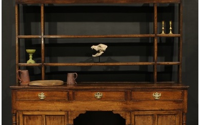 A George III oak dog kennel dresser, moulded cornice above a...