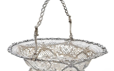 A George III silver cake basket, London 1769, William Plummer, of pierced oval form with applied foliate border and openwork twist handle, the pierced sides with beaded overlay and the repousse base raised on a pierced oval foot, 29cm wide, 34.5cm...
