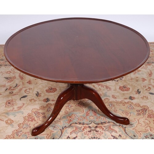 A MAHOGANY COFFEE TABLE the circular dish top above a balust...