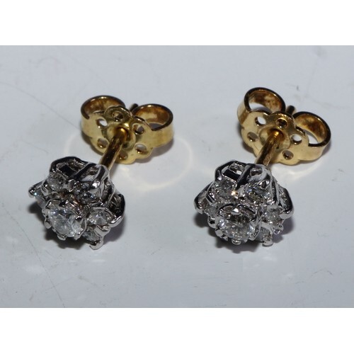 A Pair of daisy diamond cluster earrings, each set with seve...