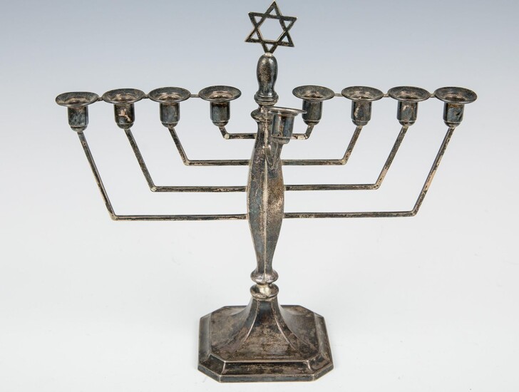A STERLING SILVER MENORAH. London, 1920's. On a square