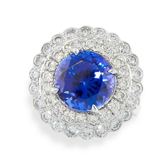 A TANZANITE AND DIAMOND RING set with a round cut