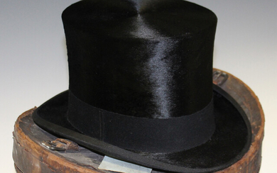 A black moleskin top hat by Henry Heath Ltd, head circumference 55cm, together with a brown leather