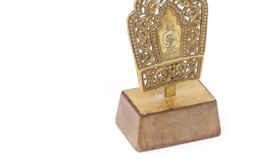 A gilt copper alloy repoussé mandorla and plaque with Buddha and deity....