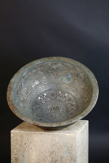A large Persian bronze basin with silver, copper and brass inlay