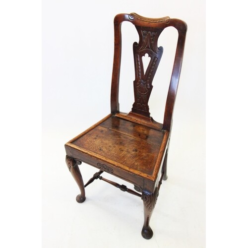 A late 17th century oak side chair, with a pierced and carve...